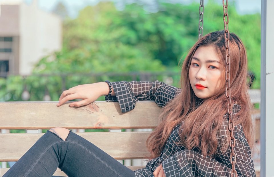Woman In Black Button-up Long-sleeved Shirt Sitting On Brown Swing Bench