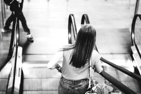 Monochrome Photography Of Woman On The Escalator photo