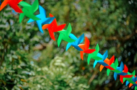 Selective Focus Photography Of Pinwheels On String photo
