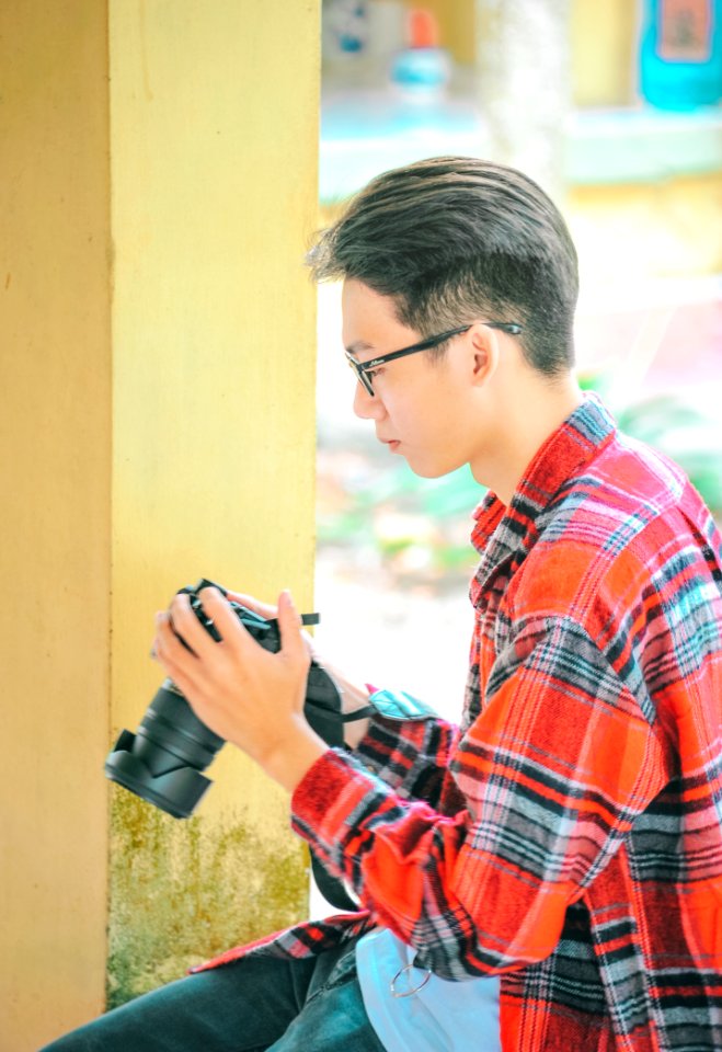 Photography Of A Man Holding Black Camerar