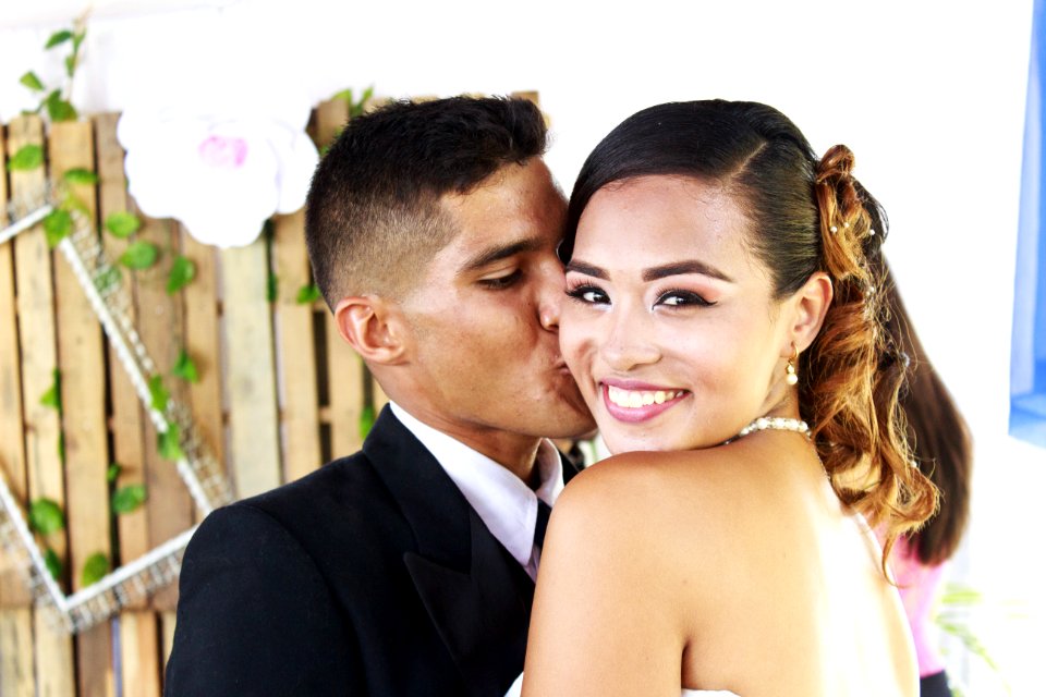 Man In Suit Kissing Woman In Cheek