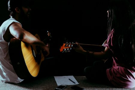 Man And Woman Playing Guitar photo