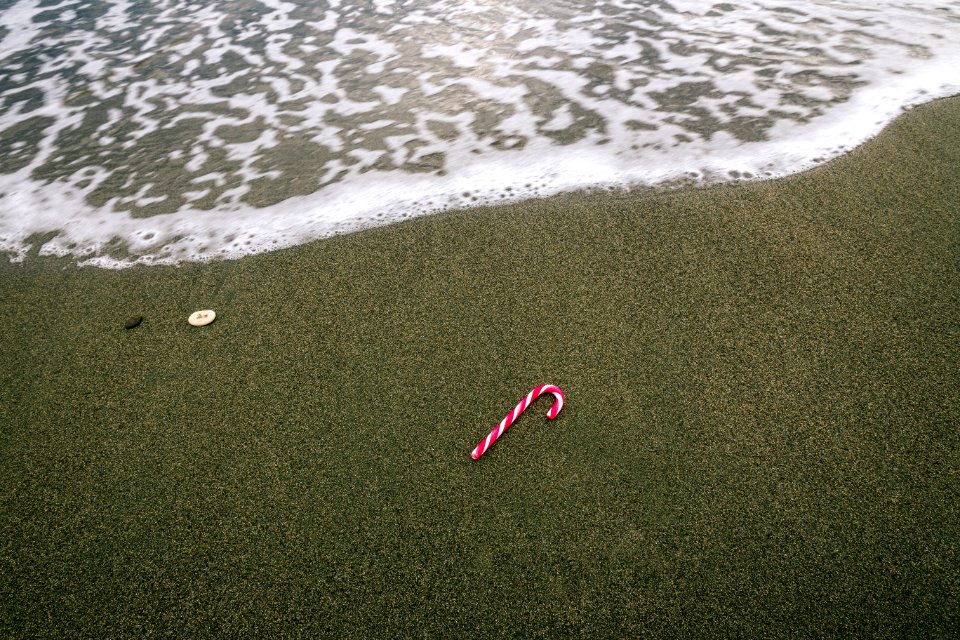 White And Red Christmas Candy On Beach Sand