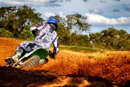 Man Riding Motocross Dirt Bike On Track photo