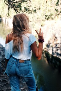 Woman In White Shirt Standing Over The River Bank photo