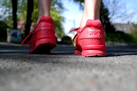 Photo Of Person Wearing Red Low-top Sneakers photo