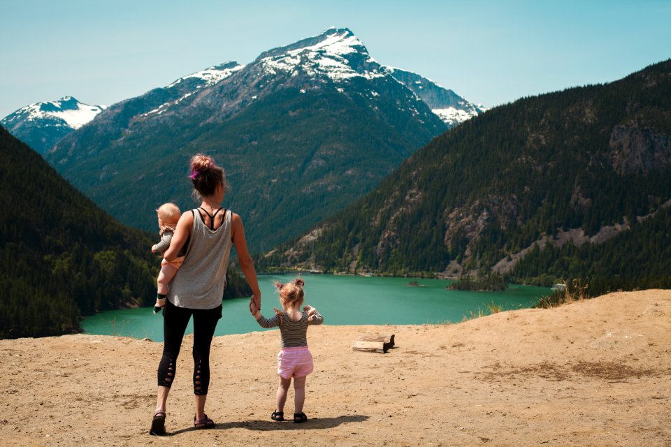 Mother And Children Walks Near Body Of Water