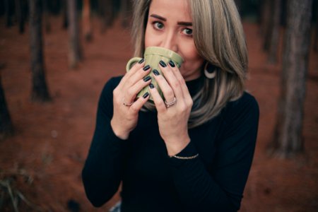 Woman Holding Grey Ceramic Mug photo