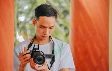 Person Holding Nikon Camera