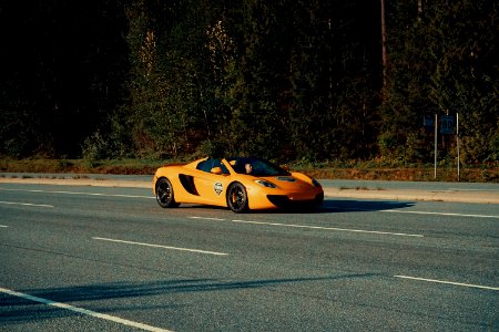 Shallow Focus Photography Of Orange Sportcar On Asphalt Road photo