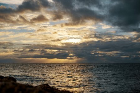 Sea Under Gray Cloudy Sky During Dawn photo