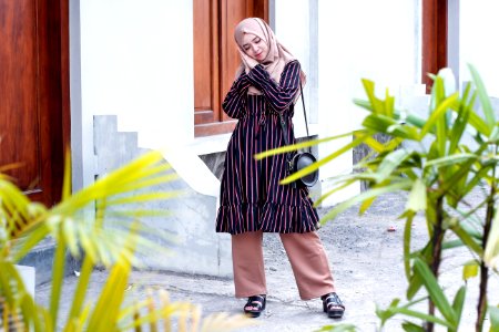 Woman Wearing Abaya Dress And Standing On Ground photo