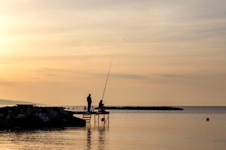 Two Person Having Fishing On Dock photo