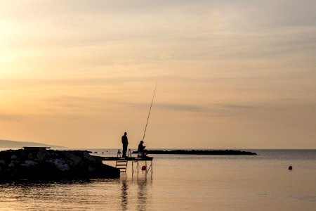 Two Person Having Fishing On Dock