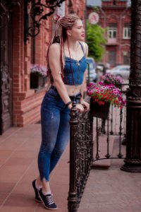 Woman Wearing Blue Crop Top Holding Handrails photo