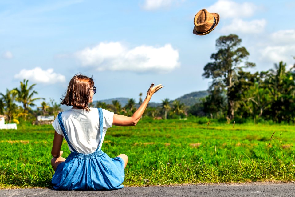 Tropical Portrait Of Young Happy Woman With Straw Hat On A Road With Coconut Palms And Tropical Trees Bali Island