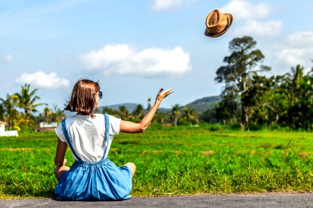 Tropical Portrait Of Young Happy Woman With Straw Hat On A Road With Coconut Palms And Tropical Trees Bali Island