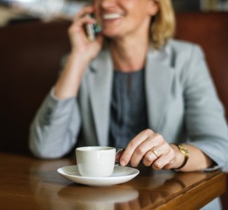 Shallow Focus Photography Of Smiling Woman Holding White Cup photo