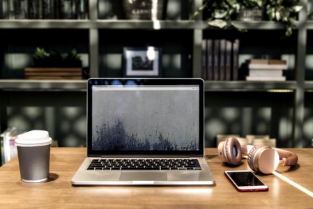 Macbook Pro On Top Of Wooden Desk photo