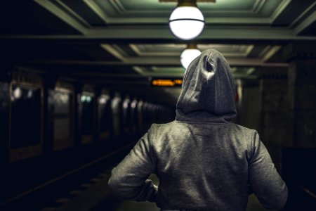 Person Wearing Gray Hooded Jacket In Train Station photo
