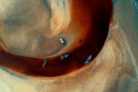 Aerial Photography Of Four Blue Boats On Body Of Water photo