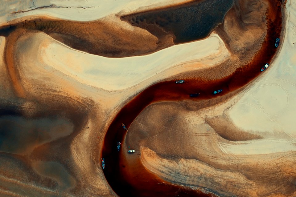 Aerial-photography Of Boats On River Surrounded By Desert