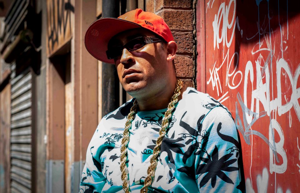 Photo Of Man Wearing Black And White Cannabis Print Top And Gold-colored Necklace photo