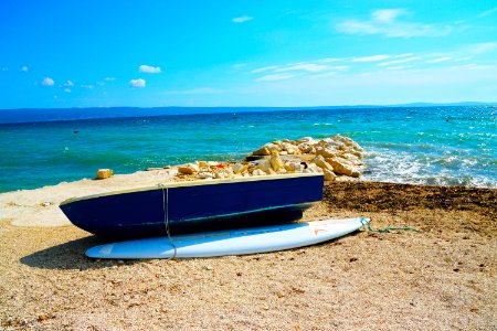 Blue Wooden Dinghy Boat Beside Body Of Water photo