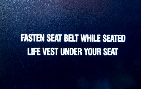 Fasten Seat Belt While Seated Life Vest Under Your Seat Text Overlay