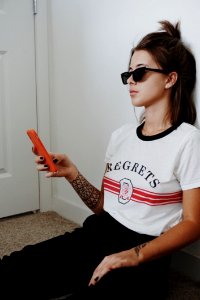 Woman Wearing Black Sunglasses Holding Android Smartphone photo