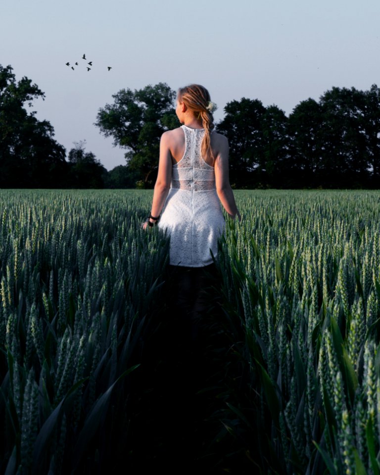 Woman In White Sleeveless Dress Near Green Plants