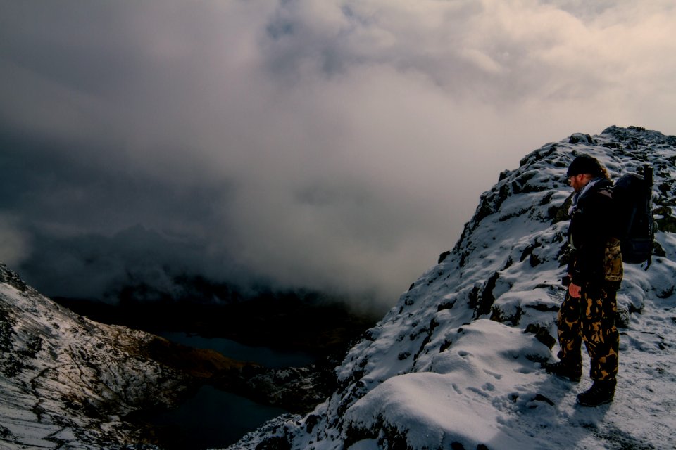 Hiker On Rocky Mountain Overlooking Valley