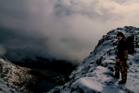 Hiker On Rocky Mountain Overlooking Valley
