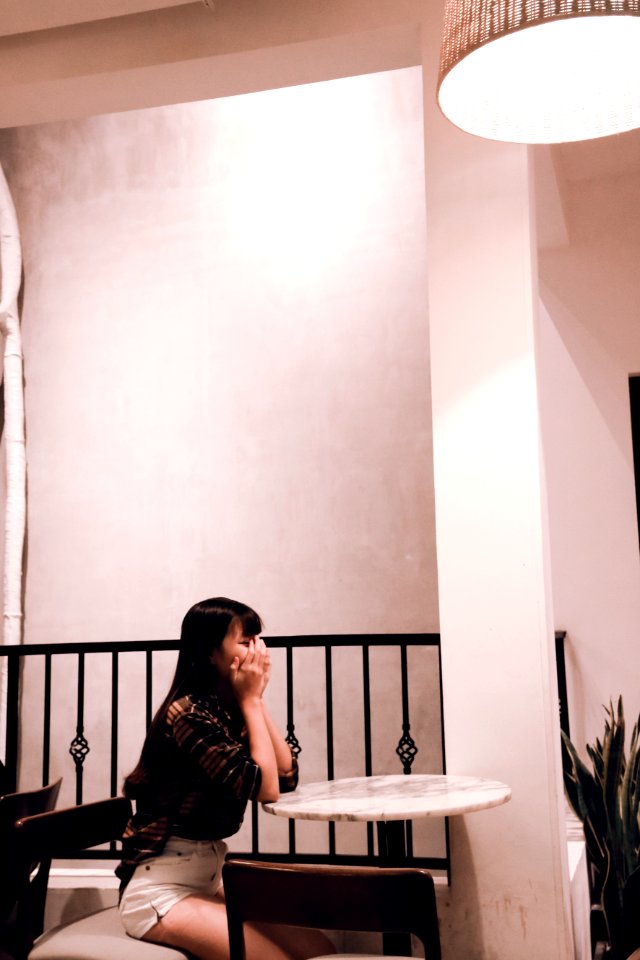 Woman Wearing Brown Plaid Dress Sitting On Chair