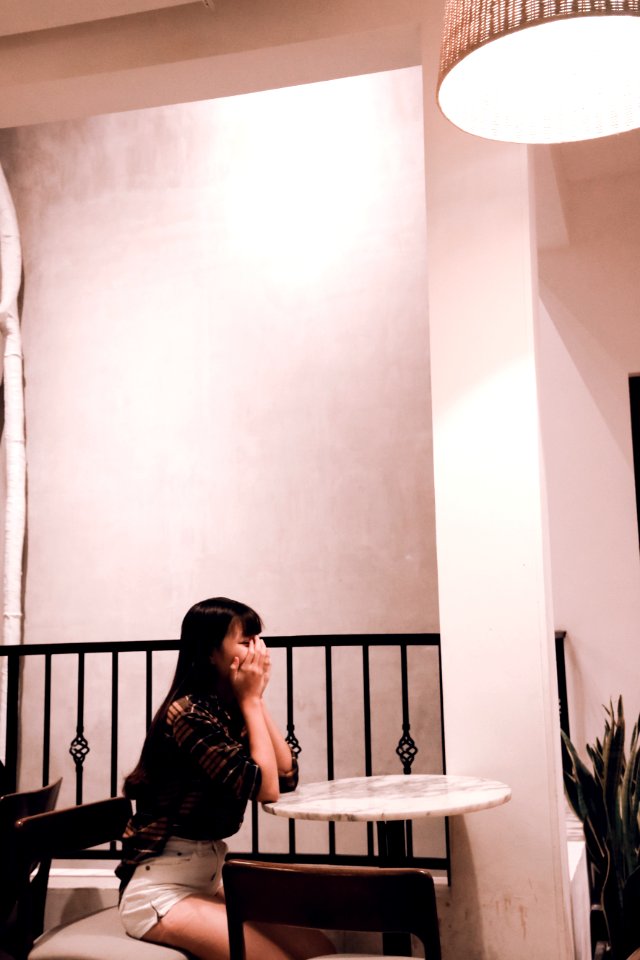 Woman Wearing Brown Plaid Dress Sitting On Chair photo