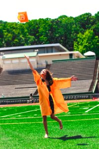 Woman In Orange Academic Dress photo