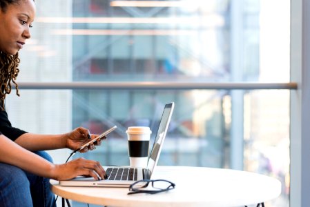 Woman Wearing Black Sweater Using Laptop Computer Inside The Room photo