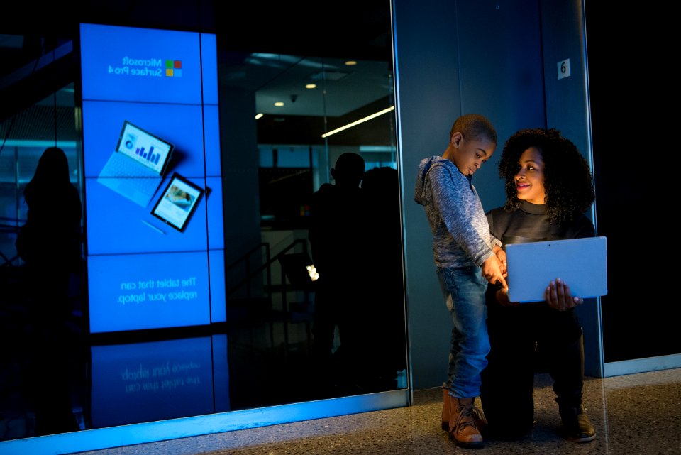 Woman Together With Children Holding Laptop Computer