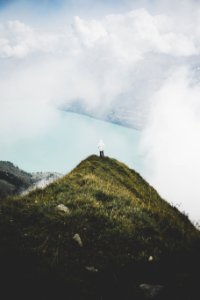 Person Standing On Green Grass Mountain photo