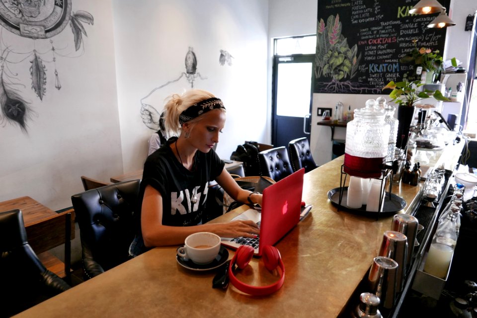 Woman Wears Black Kiss Print Crew-neck Shirts Sits