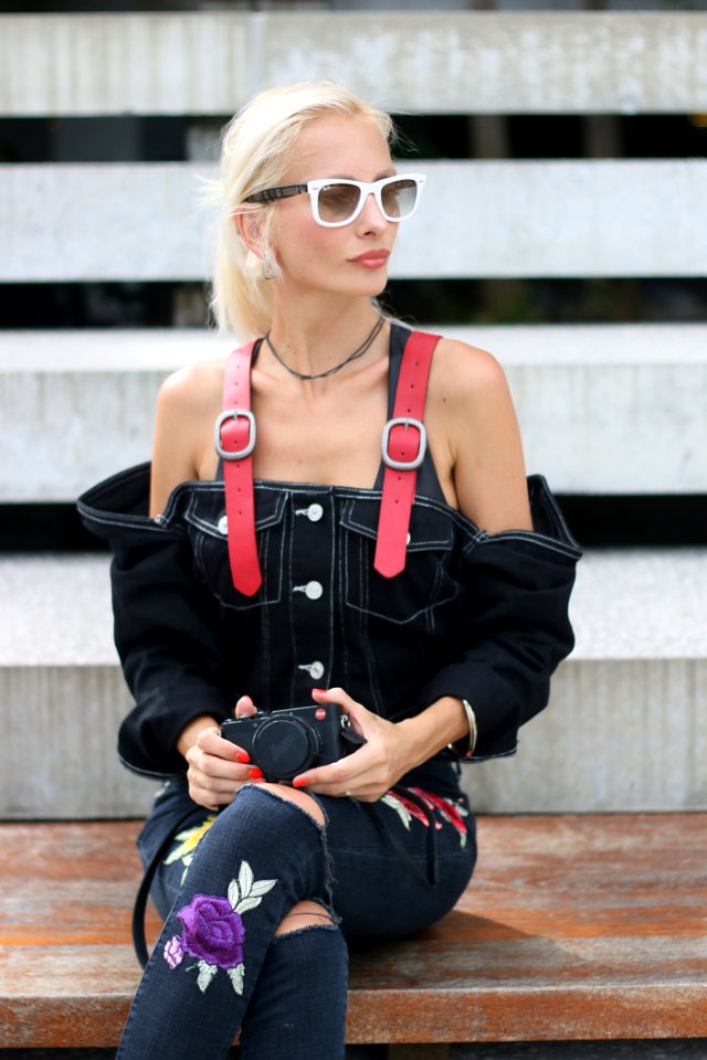 Woman In Black Denim Off-shoulder Top Sitting On Board While Holding Black Camera