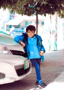 Photo Of A Boy Leaning On Car photo