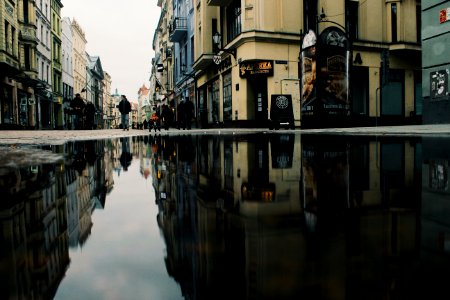 Reflection Of Buildings On Puddle photo