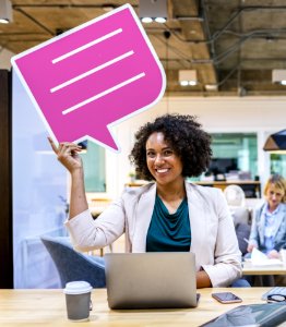 Woman Wearing Blazer Holding Pink And White Chat Bubble photo