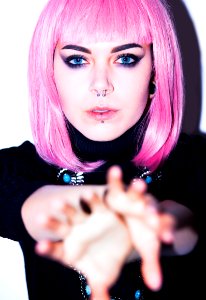 Pink Haired Woman Wearing Black Shirt With Nose And Lip Piercings photo