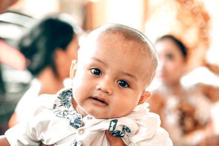 Baby In White Top In Tilt Shift Lens Shot