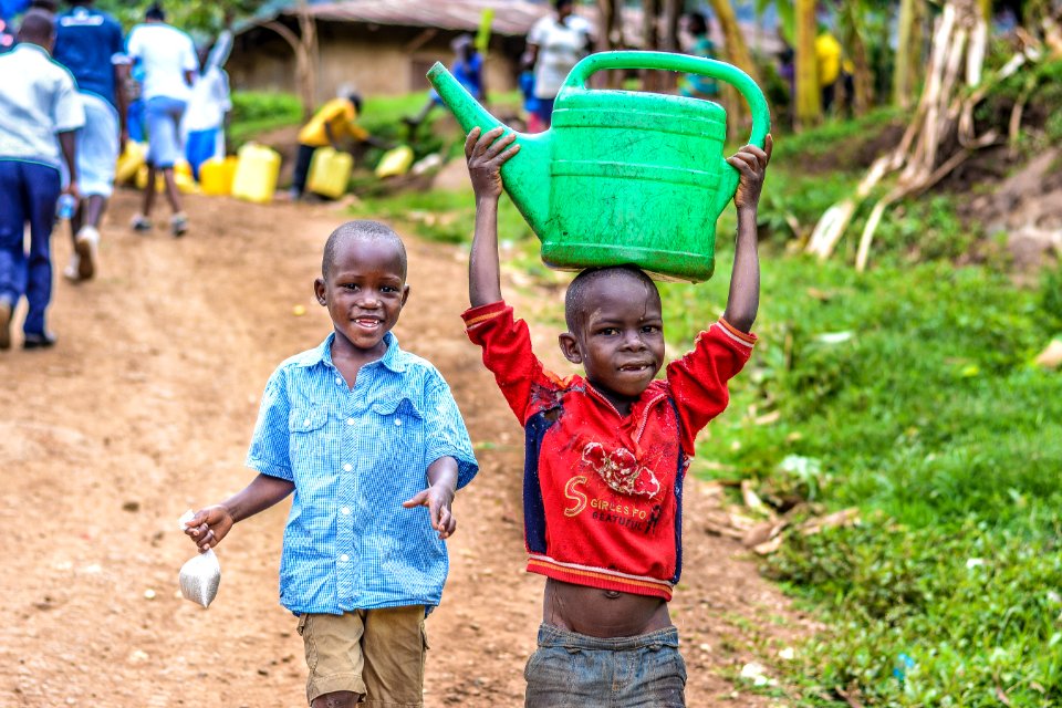 Two Boys Walking Beside The Grass