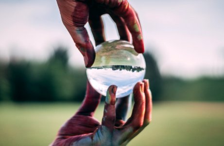 Person Holding Clear Ball In Shallow Focus Photography photo