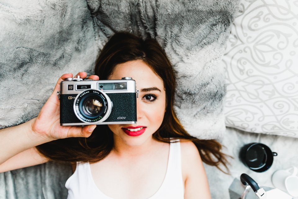 Woman Wearing White Tank Top Holding Black Camera photo