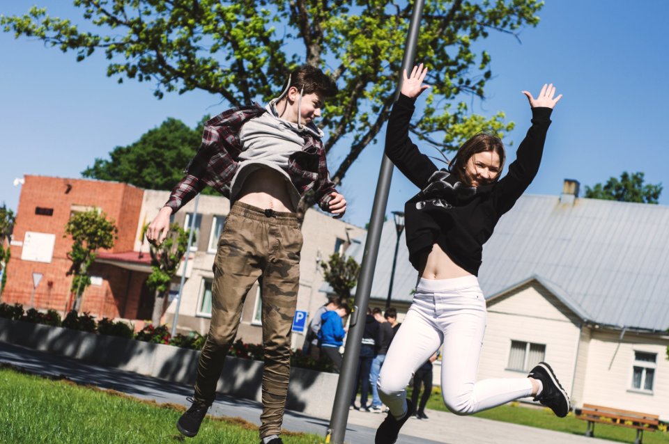 Woman In Black Sweatshirt And White Pants